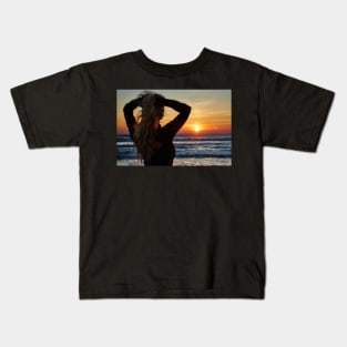 Beautiful woman on the beach at sunrise Kids T-Shirt